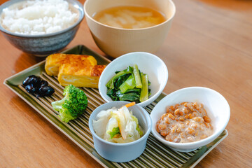 Traditional Japanese breakfast with rice, miso soup, natto and side dishes