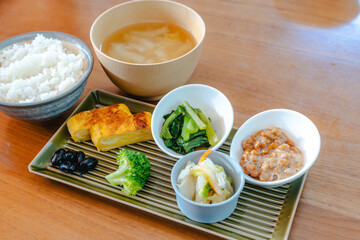 Traditional Japanese breakfast with rice, miso soup, natto and side dishes