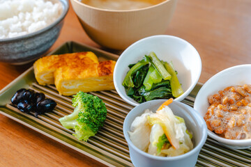 Traditional Japanese breakfast with rice, miso soup, natto and side dishes