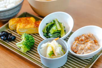 Traditional Japanese breakfast with rice, miso soup, natto and side dishes