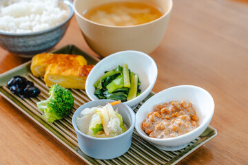 Traditional Japanese breakfast with rice, miso soup, natto and side dishes