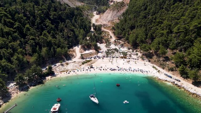 Porto Vathy beach, sand and umbrellas on beach, Thassos Island, Greece. One of the most beautiful beaches in Greece. Amazing beach with clear blue water. Aerial panoramic drone view from above, top vi