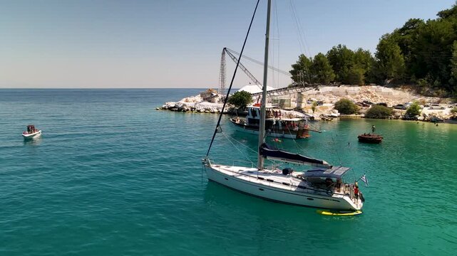 Porto Vathy beach, sand and umbrellas on beach, Thassos Island, Greece. One of the most beautiful beaches in Greece. Amazing beach with clear blue water. Aerial panoramic drone view from above, top vi