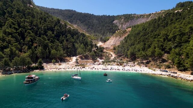 Porto Vathy beach, sand and umbrellas on beach, Thassos Island, Greece. One of the most beautiful beaches in Greece. Amazing beach with clear blue water. Aerial panoramic drone view from above, top vi