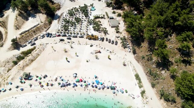 Porto Vathy beach, sand and umbrellas on beach, Thassos Island, Greece. One of the most beautiful beaches in Greece. Amazing beach with clear blue water. Aerial panoramic drone view from above, top vi