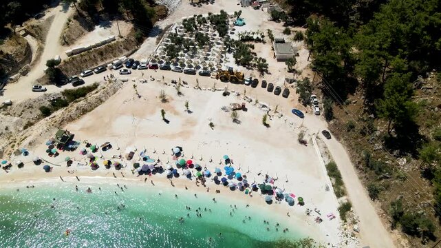 Porto Vathy beach, sand and umbrellas on beach, Thassos Island, Greece. One of the most beautiful beaches in Greece. Amazing beach with clear blue water. Aerial panoramic drone view from above, top vi