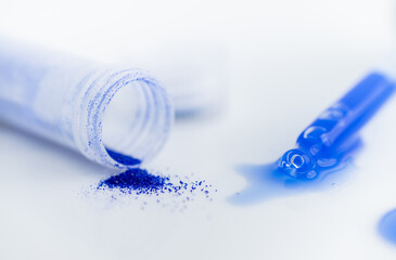 Close up of Blue Copper Peptides in Powder and Liquid Form
