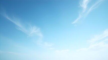 Vast clear blue sky with delicate wispy white clouds, a serene and peaceful natural background image perfect for tranquility, freedom, and open space.