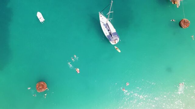 Yachts in sea on Porto Vathy beach, Thassos Island, Greece. Amazing beach with clear blue water. Aerial panoramic drone view from above, top view from drone. Summer holidays Europe
