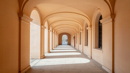 Arched corridor with symmetry perspective in orange historic building