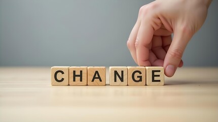 Change Management Concept: Wooden Blocks Spelling "CHANGE" on Tabletop, Hand Adjusting Letters, Business Strategy, Transformation, Growth