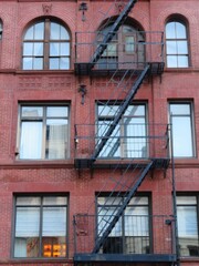 Obraz premium an old building with metal fire escapes in front in Tribeca, Manhattan, New York