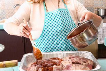Pork leg being marinated, preparing meat
