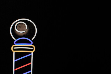 neon barber shop light on black background