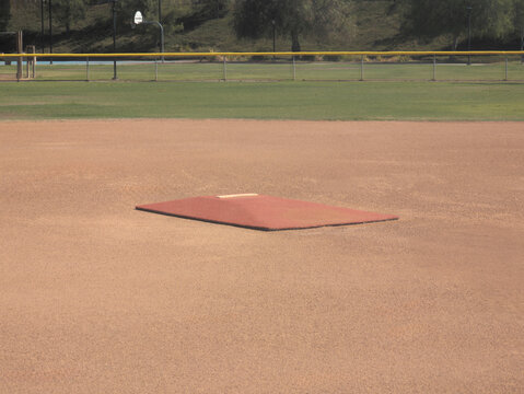 A portable pitcher's mound set up on a baseball field