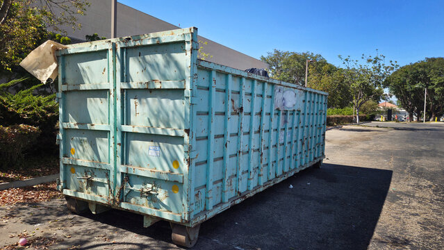 A Large Dumpster Near a Construction Site