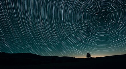 Spinning Star Trails Over Dark Silhouette Landscape at Night