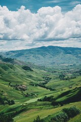 Green Valley And Mountain Landscape With Cloudy Sky