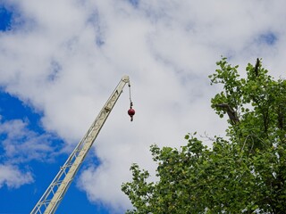 Construction crane hook set against blue sky