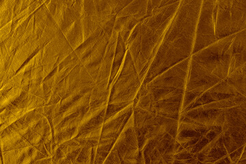 Wrinkled golden foil texture background.
