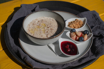 Reserved breakfast at a cafe. A plate of porridge on a table in a street cafe. 