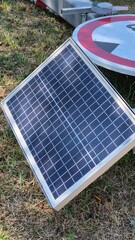 A solar-powered road barrier and a sign lie on the ground, damaged and out of service. The scene highlights vandalism, broken infrastructure, and the impact on public safety and transport systems.