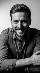 Obraz premium Smiling Young Man Wearing Dark Shirt in Studio Portrait Black and White