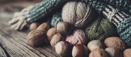 A close-up depicts a collection of yarn balls, nuts, and a knitted item on a rustic wooden surface