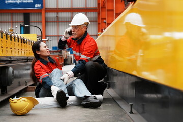 Asian woman, a product inspection worker, had an accident and fell, hurting her ankle, and sat on the factory floor. A senior supervisor came to help, holding a walkie-talkie, and called for help.