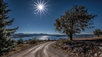 Sunny vista; dirt road winding to a lake