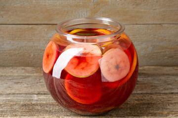 Tasty fruity punch on wooden table, closeup. Refreshing drink