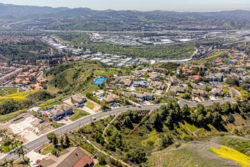Fototapeta premium Yorba Linda, Orange County, CA, California, April 11, 2024: Aerial Drone City View toward Hidden Hills Road with Homes, Houses, Streets, Mountain Community Villages 