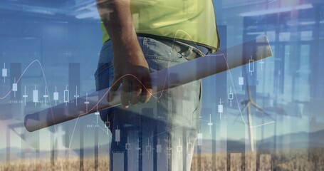 Holding blueprint, engineer wearing neon shirt surveying grass by turbines with overlay, copy space