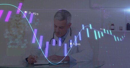Writing doctor wearing coat, stethoscope, recording chart notes at glass desk, with hologram charts