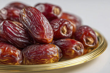 Dried Dates on Shiny Gold Tray on Transparent Background