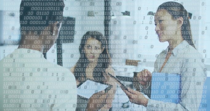 Reviewing patient data medical team working in clinic hall, with clipboard, tablet, binary overlay