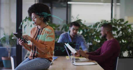 Using tablet woman collaborating with colleagues using laptop and documents in office, copy space