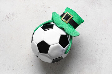 Soccer ball with leprechaun's hat on white grunge background. St. Patrick's Day celebration