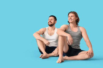 Obraz premium Men sitting on blue background. Body positive concept