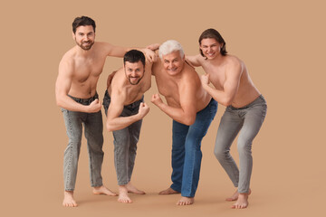 Group of men showing muscles on beige background. Body positive concept