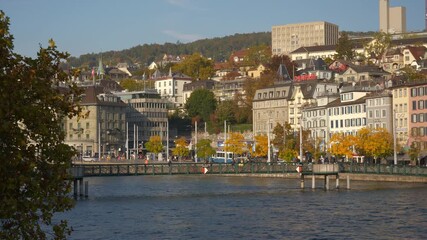 sunny day autumn time zurich city center downtown famous riverside pedestrian bridge panorama 4k switzerland