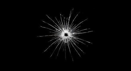Fototapeta premium Shattered Illusion: A close-up view of a glass pane, violently pierced by a bullet, revealing a complex starburst fracture pattern against a stark black backdrop.