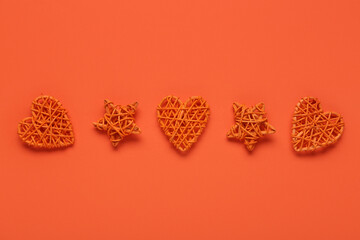 Decorative woven stars and hearts on orange background
