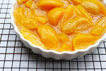 Sliced peaches in syrup served in a bowl