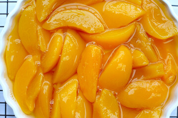 Sliced peaches in syrup served in a bowl