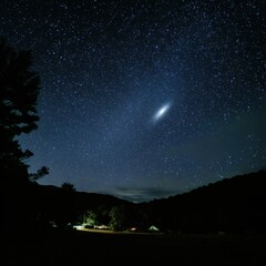 The Andromeda Galaxy appears as a faint smudge in space.