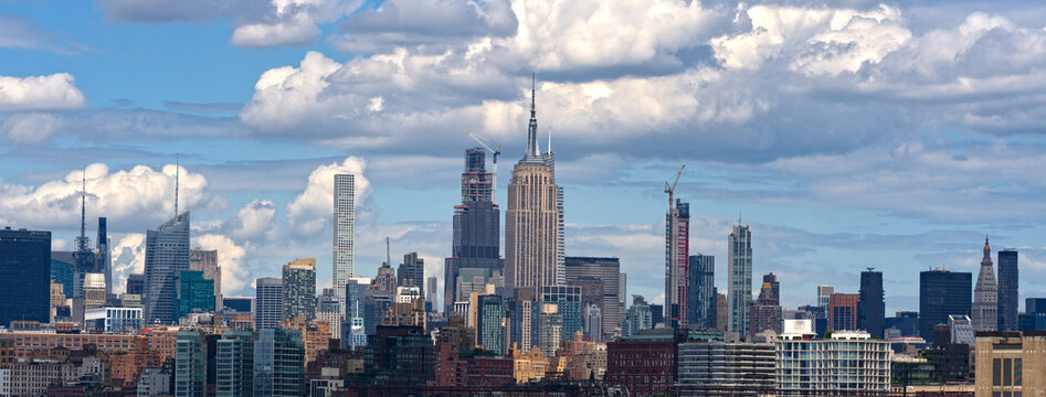 New York city. NYC cityscape. Lower Manhattan and One World Trade Center in New York Cit. Skyscrapers of Manhattan located near rippling water of New York bay against blue sky. New York skyscrapers. - Powered by Adobe