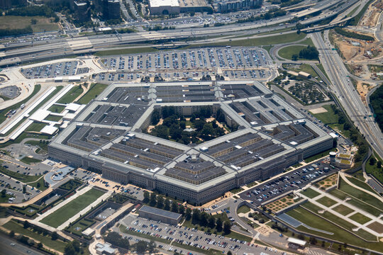 Aerial view of the Pentagon complex with surrounding roads, parking and greenery. g.