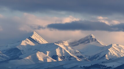 Snowy mountain peaks rise dramatically against a soft, pastel sky, bathed in the gentle light of dawn.