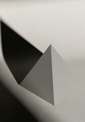 Fototapeta premium Geometric abstraction with pyramid object and dramatic shadow play